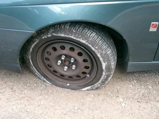 Picture of flat tire in the mud
