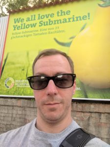 selfie of mpyne in front of an ad for a yellow submarine